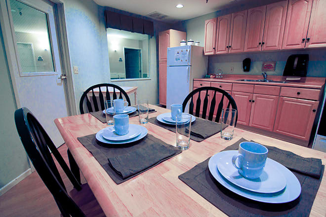 A cozy kitchen and dining area with a set table ready for a meal.