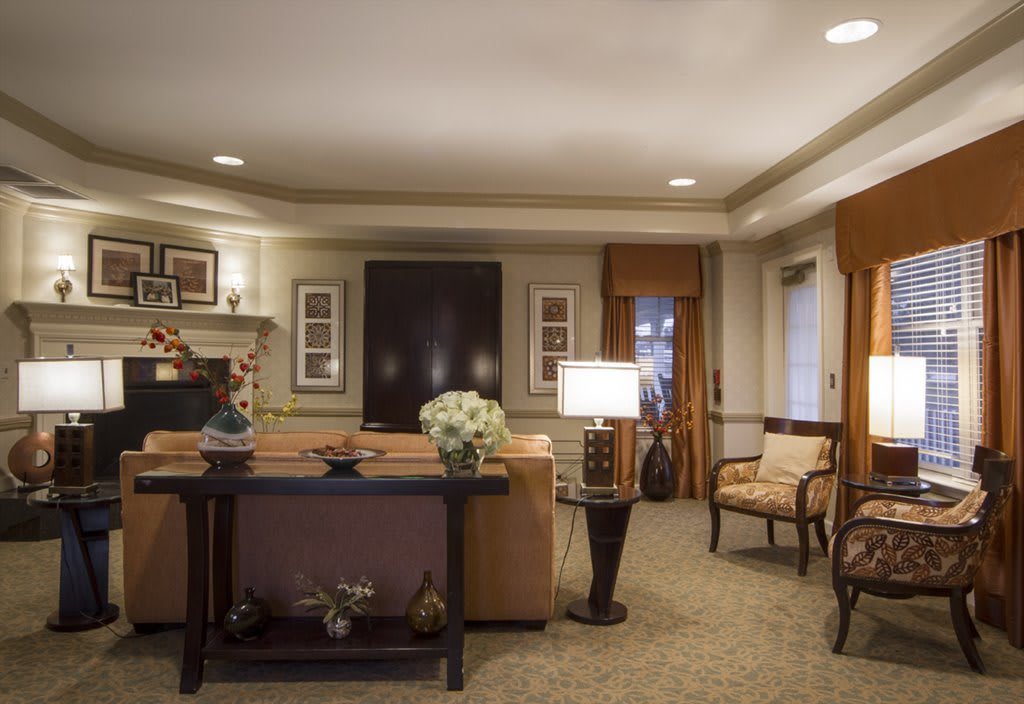 A cozy and elegantly furnished living room with warm lighting.