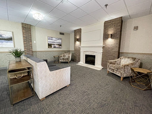 A cozy living room featuring a fireplace and comfortable seating, designed for relaxation.