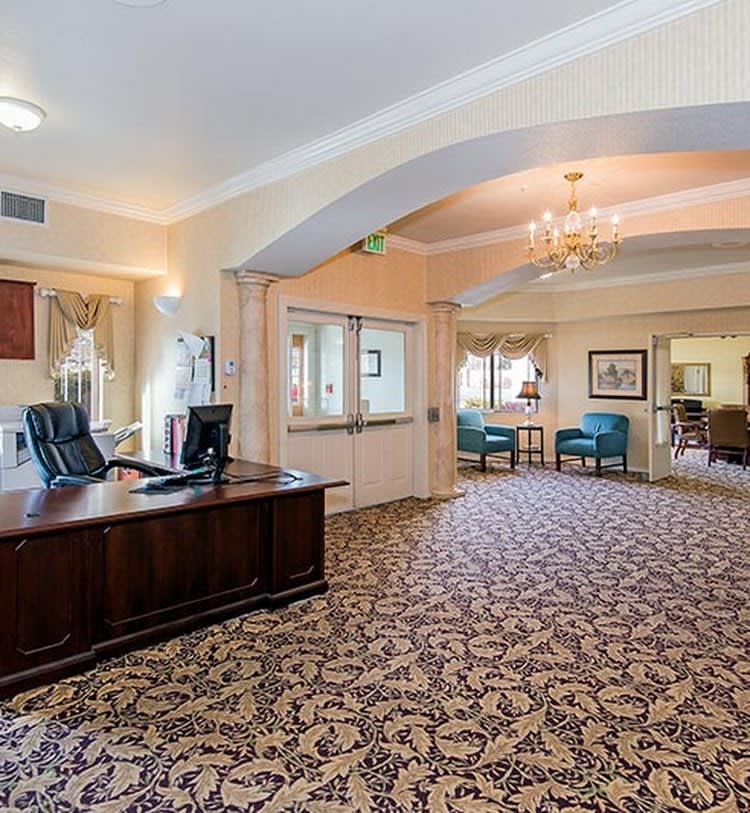 A spacious office lobby with a reception desk and elegant furnishings.