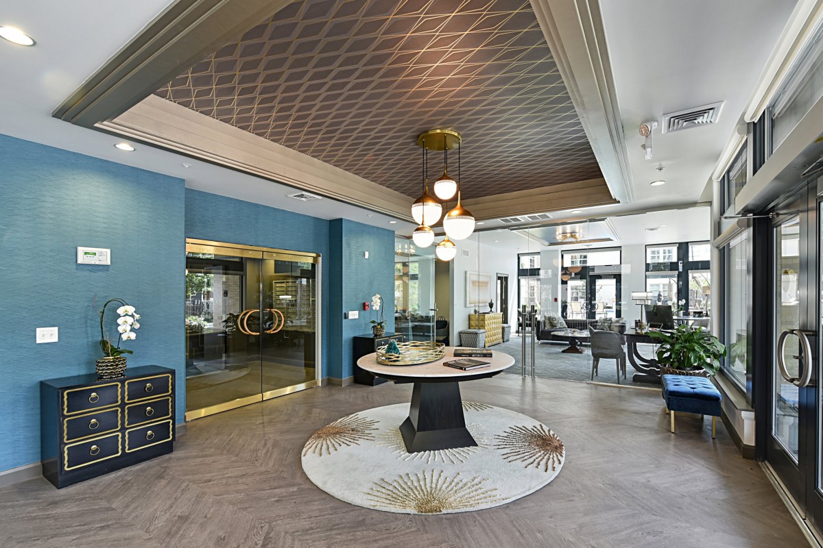 A stylish lobby featuring modern furniture and elegant chandeliers.