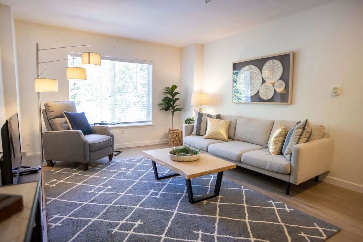 A modern living room with a cozy seating area, stylish furniture, and elegant decor.