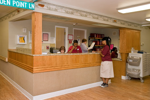 A busy reception area with staff assisting customers.