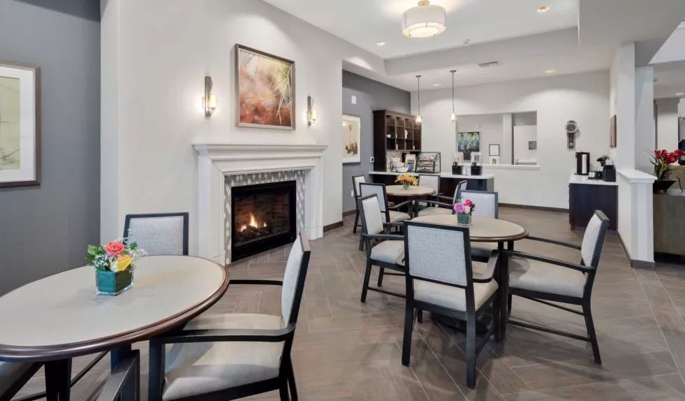 A modern interior space featuring a cozy seating area with a fireplace and elegant decor.