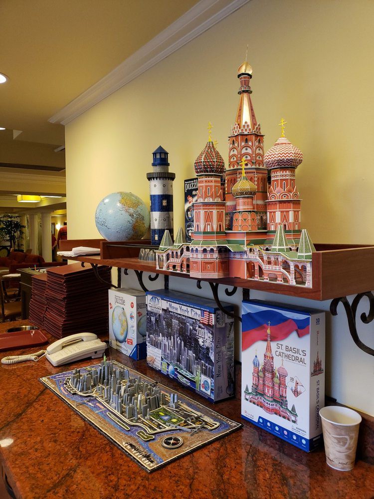 A shelf displaying various souvenirs including a model of St. Basil's Cathedral, a lighthouse, and a globe.