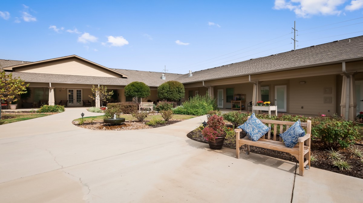 A serene courtyard with seating areas and lush landscaping.