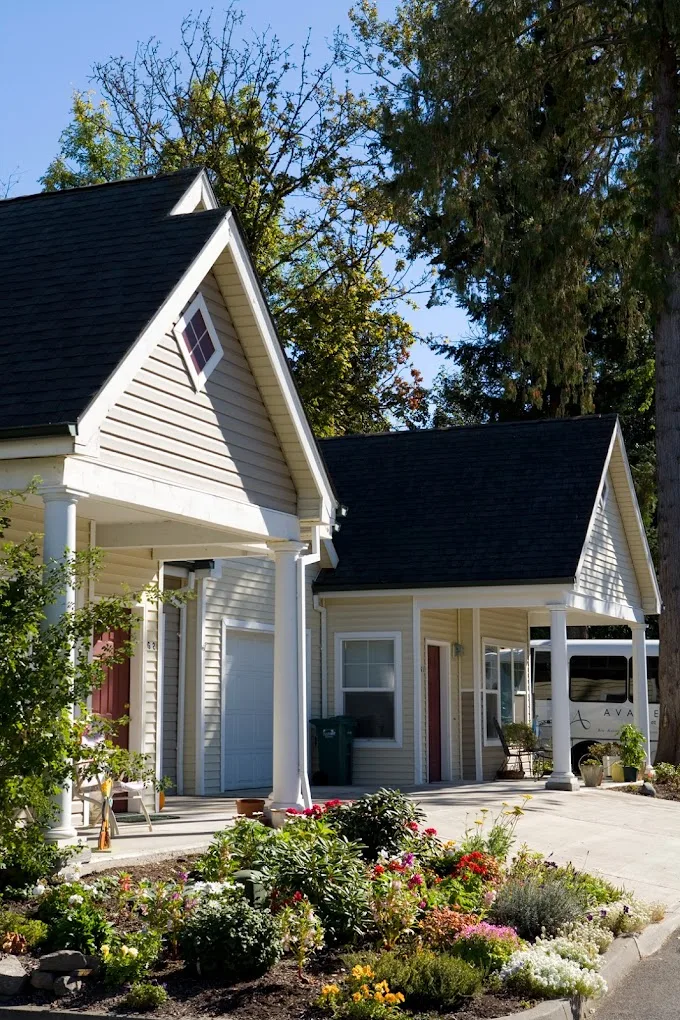 A charming suburban house with a pitched roof and a driveway.