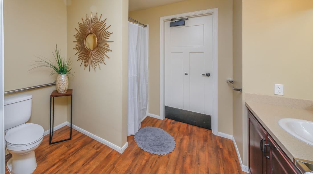 Cozy entryway with hardwood floors and decorative wall art.