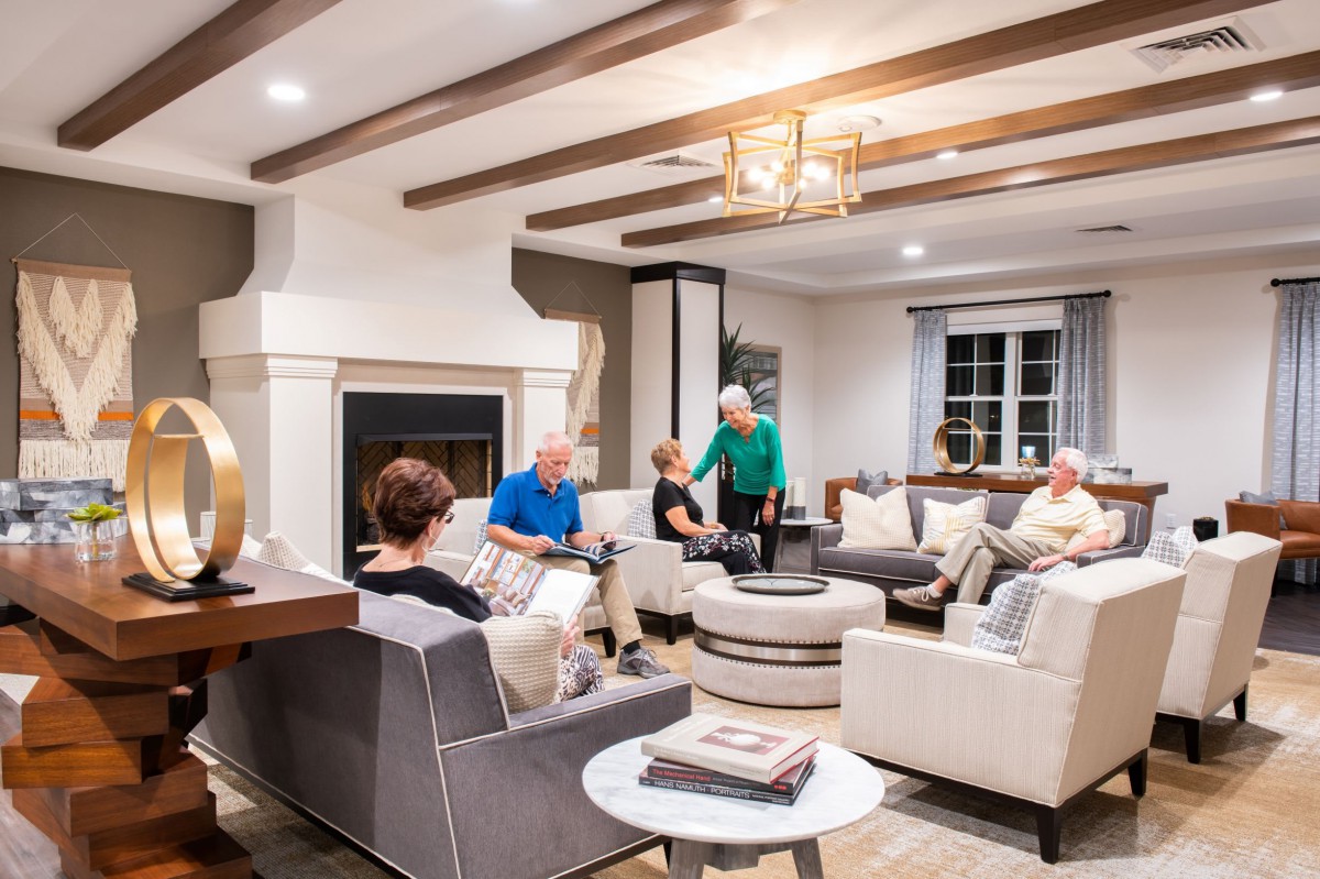 A group of people enjoying a social gathering in a cozy living room.