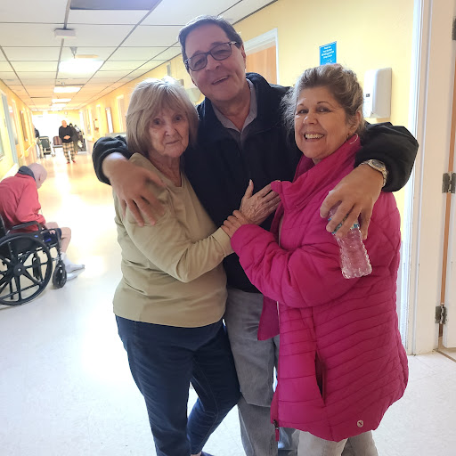 A warm moment shared among friends and family in a hospital setting.
