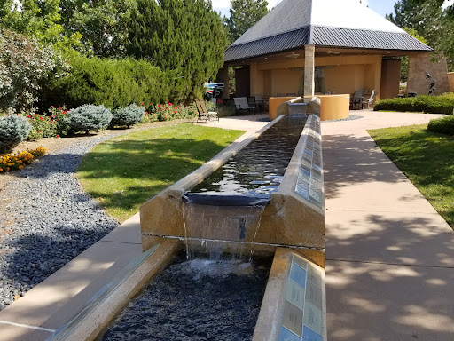 A serene water feature flows through a beautifully landscaped garden.