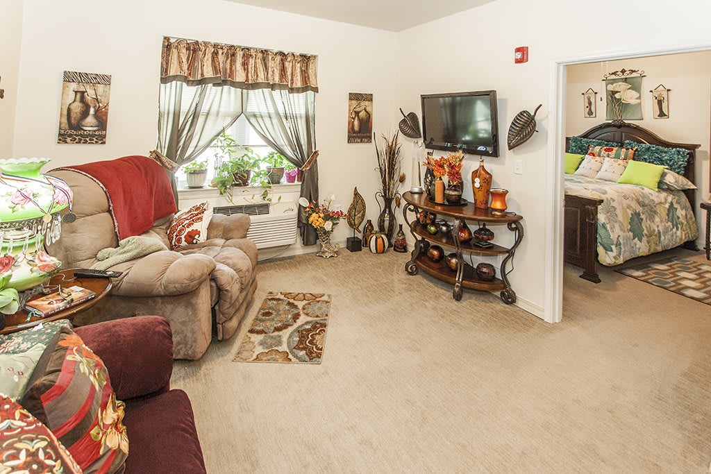 A cozy living room with comfortable seating and decorative elements.