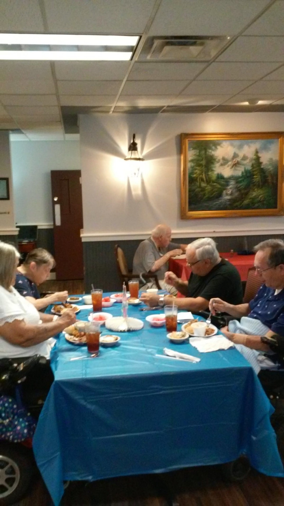 A group of people enjoying a meal together in a restaurant setting.