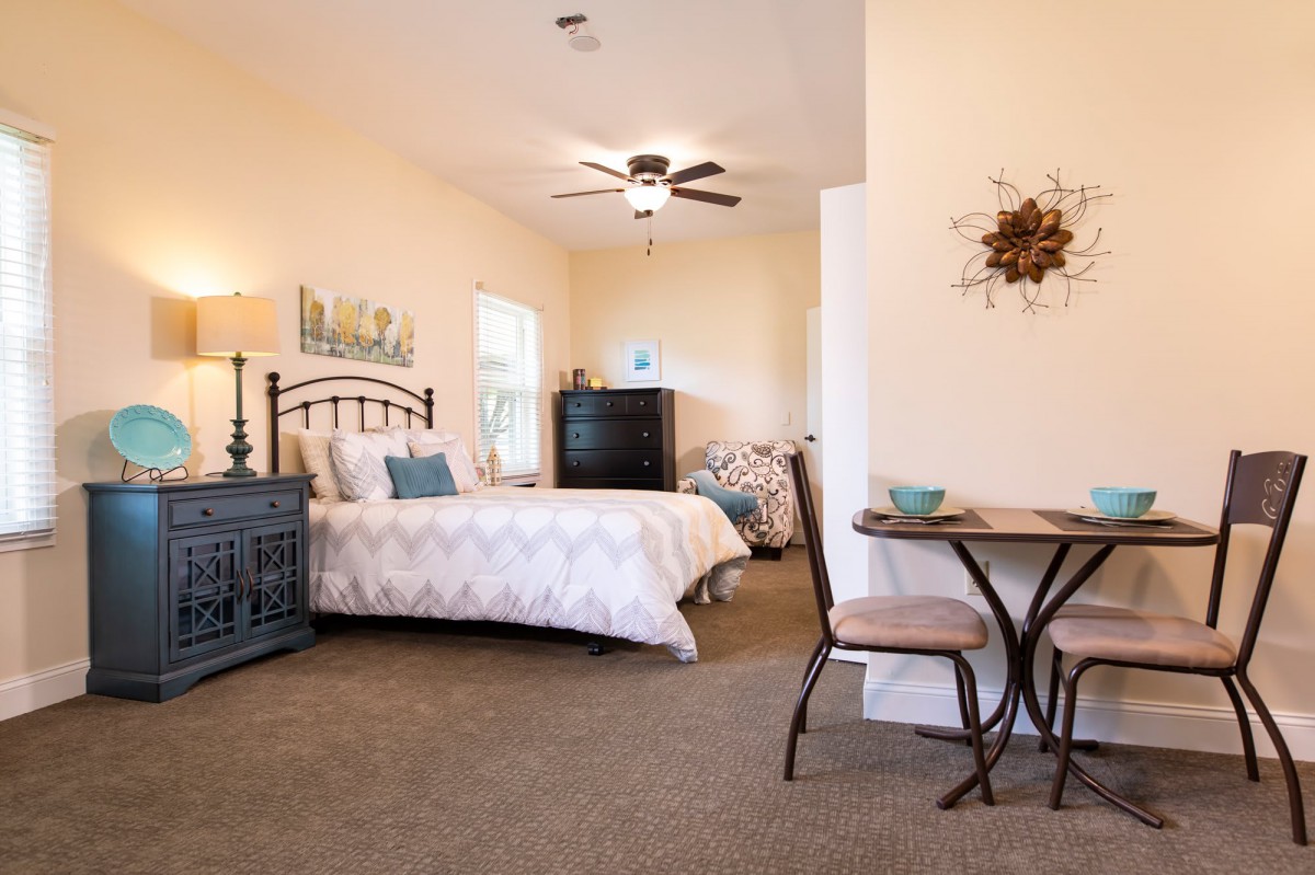 A cozy bedroom with stylish decor and comfortable furnishings.