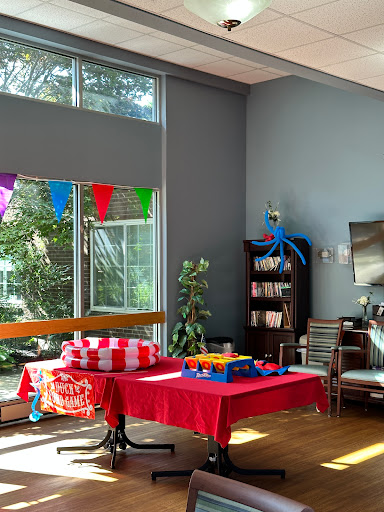 A vibrant living room setup decorated for a party, featuring colorful banners and a cozy atmosphere.