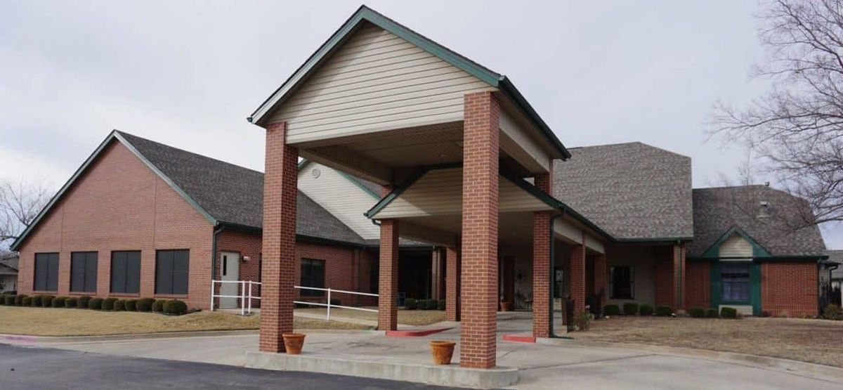 A brick building entrance with a covered walkway.