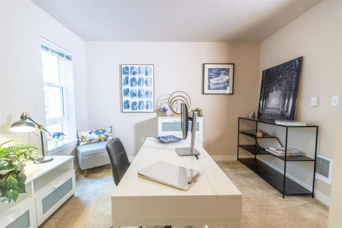 A neatly organized home office with modern furniture and decor.