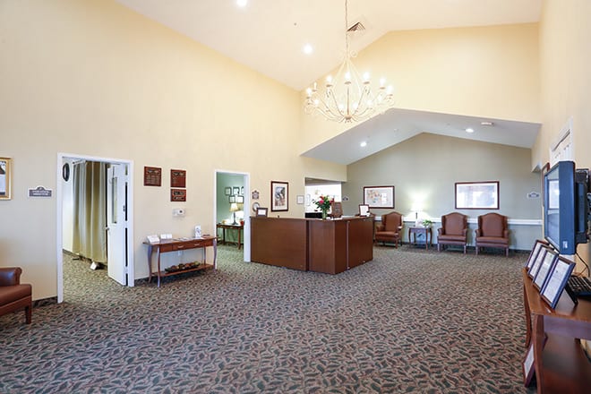 A spacious and welcoming lobby with a reception desk and comfortable seating.