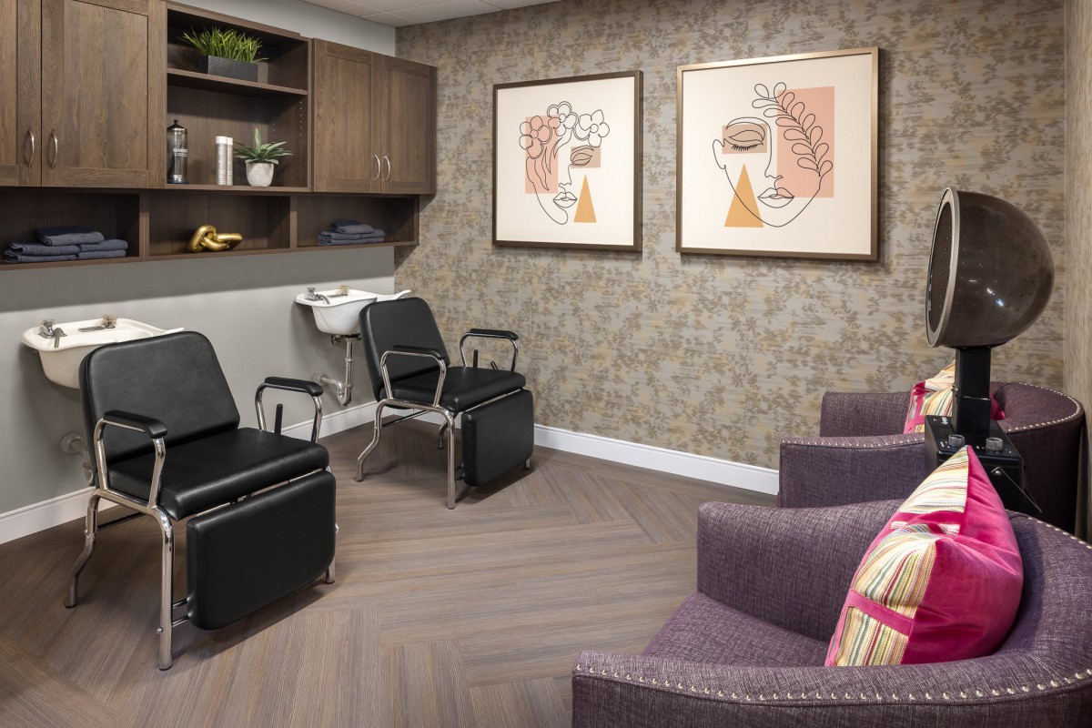A modern office seating area with stylish chairs and artwork adorning the walls.