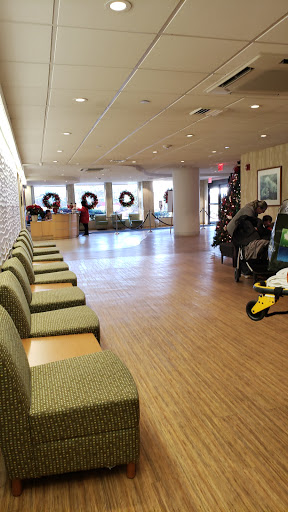 A spacious lobby featuring festive holiday decorations and comfortable seating.
