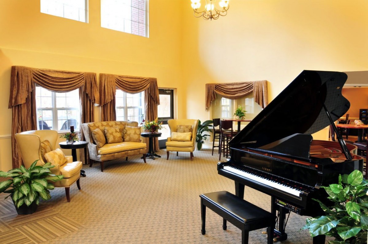 A luxurious living room featuring a grand piano and elegant furnishings.