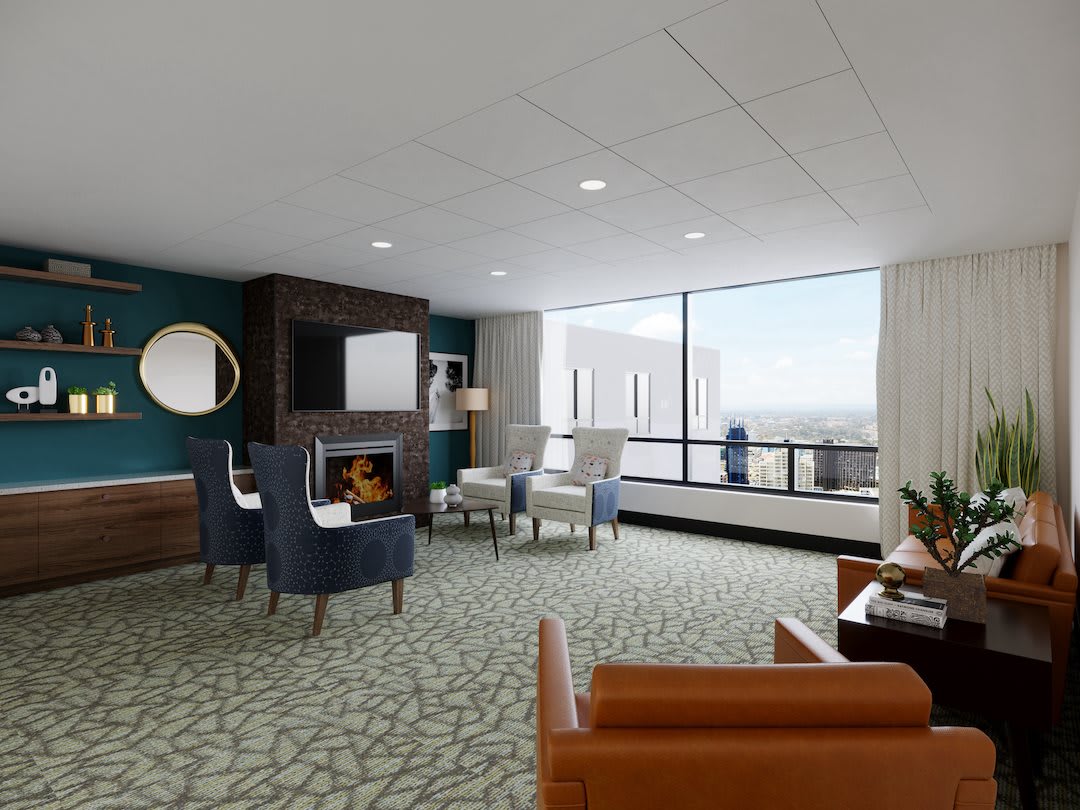 A modern living room with comfortable seating and a large window offering a scenic view.