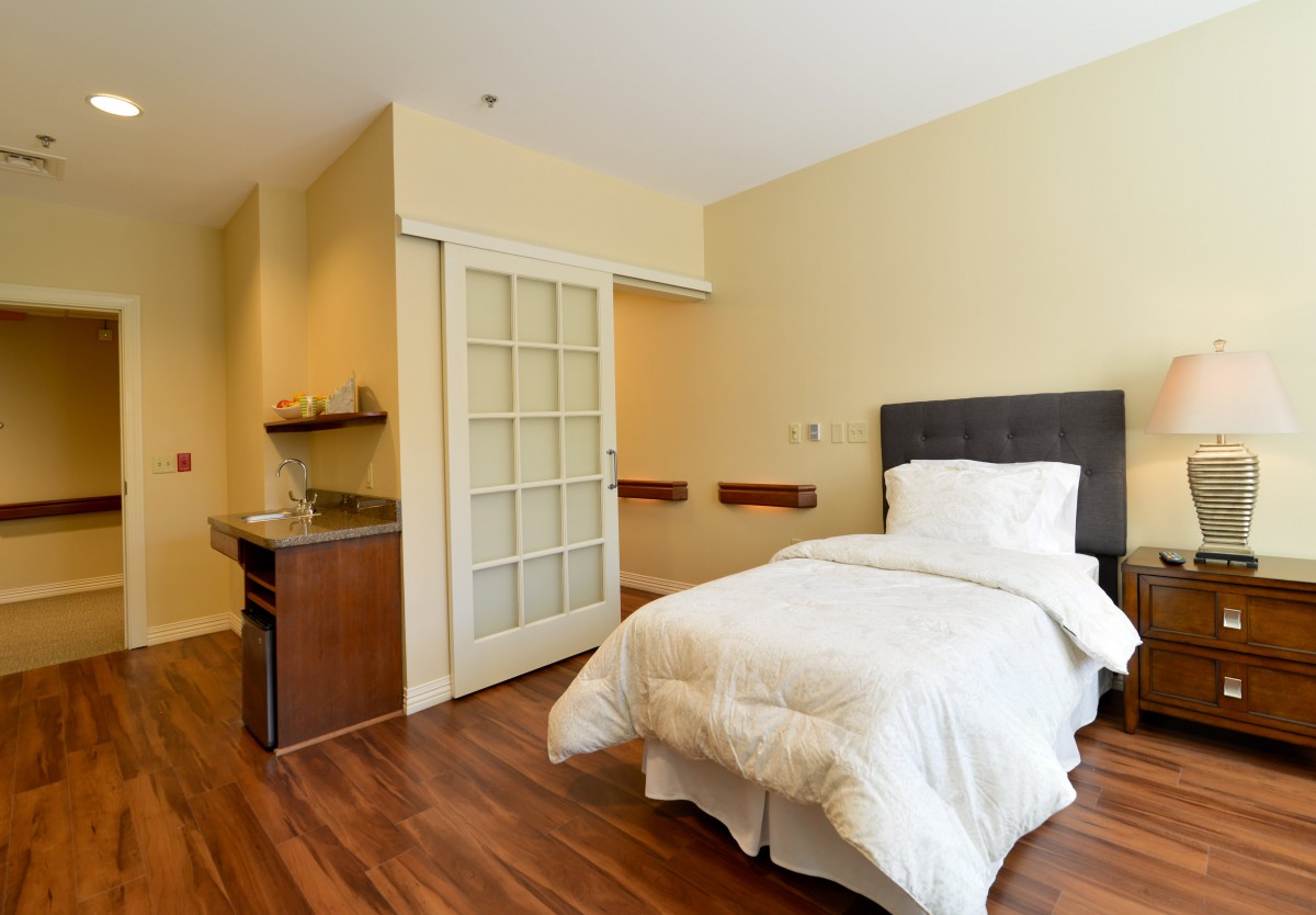 A minimalist bedroom with a single bed and modern decor.