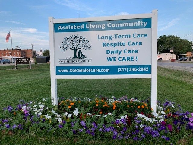A sign for an assisted living community offering long-term care, respite care, and daily care services.