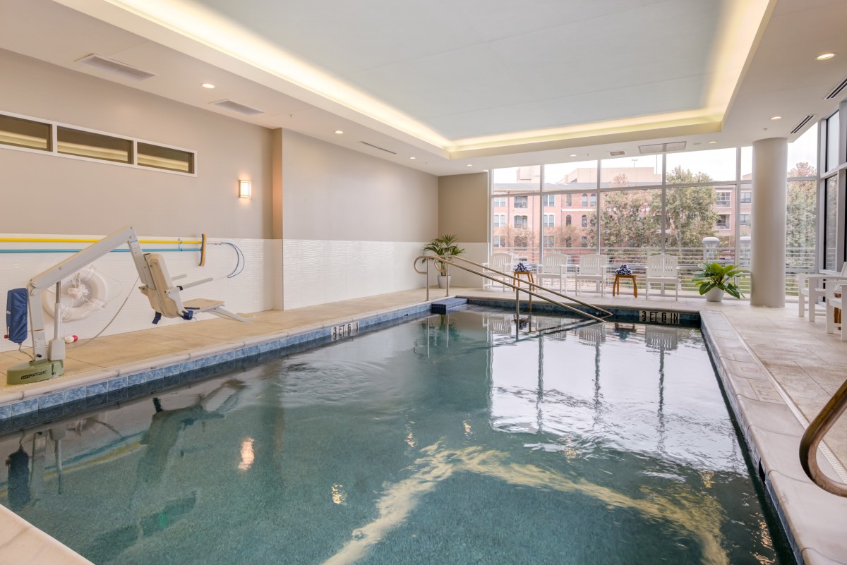A luxurious indoor swimming pool with elegant lighting and serene atmosphere.