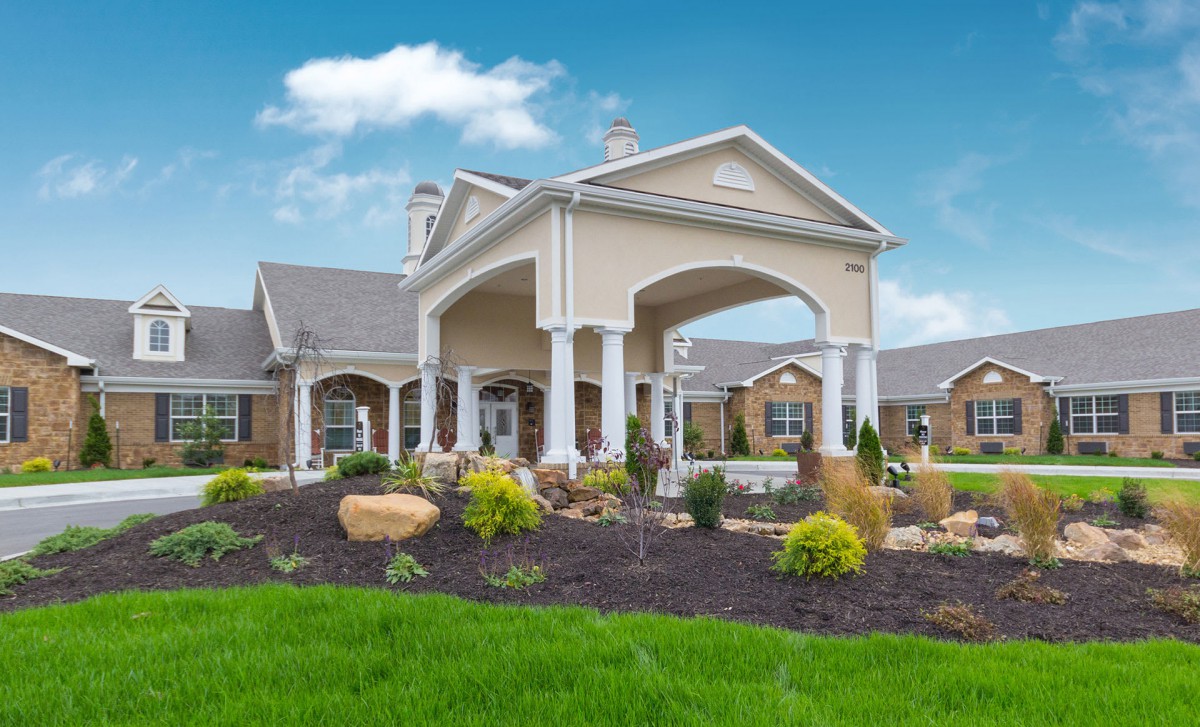 A beautiful residential building with a landscaped garden and grand entrance.