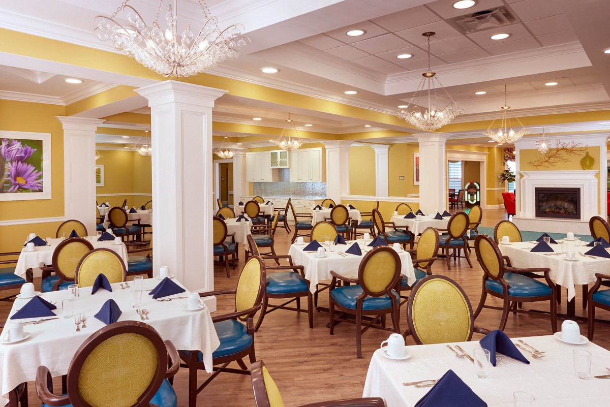 An elegant dining room with neatly set tables and classic decor.