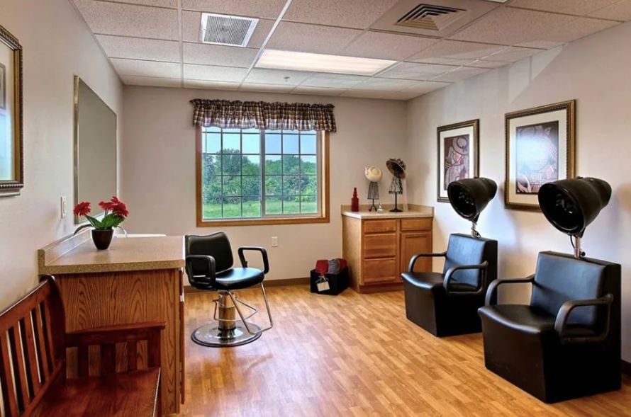 Interior of a hair salon with chairs, mirrors, and wooden flooring.