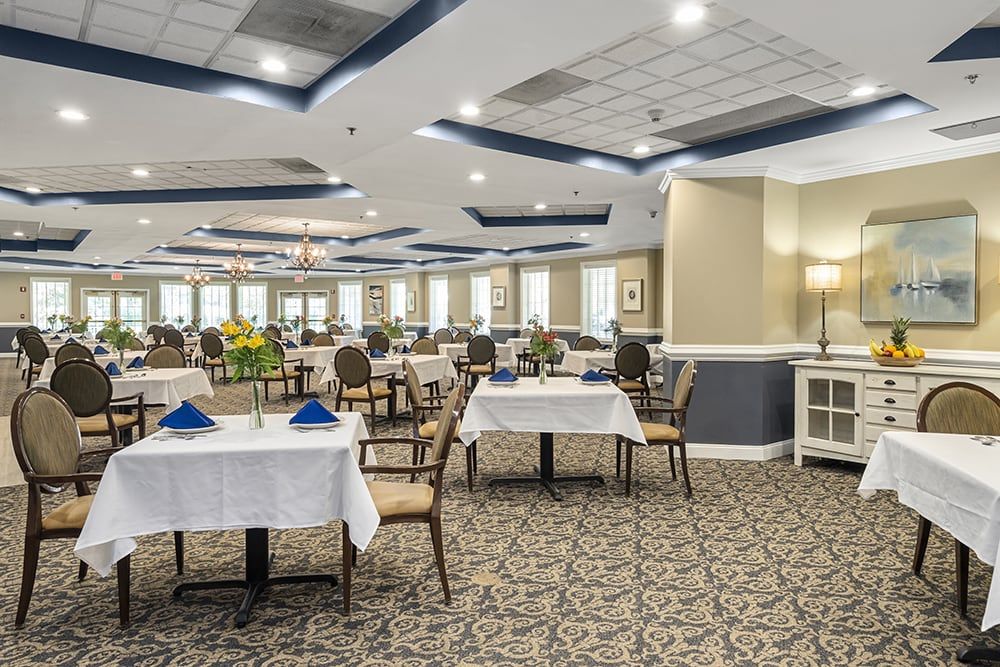 A spacious and elegantly decorated dining area with neatly arranged tables and chairs.
