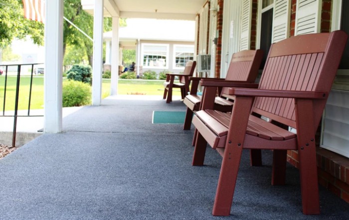 A serene porch with wooden chairs, perfect for relaxation.