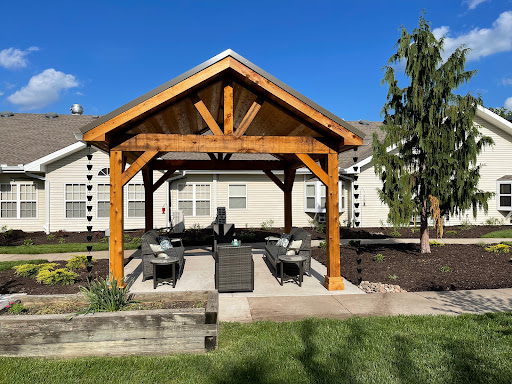 A beautifully designed wooden pergola providing a cozy outdoor seating area.