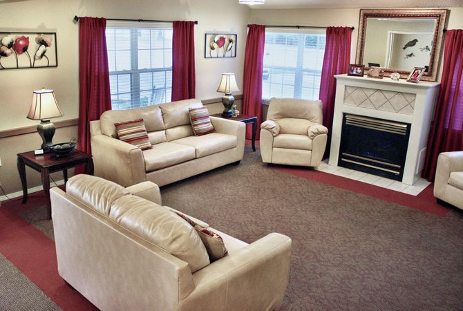 A cozy living room with comfortable seating and a fireplace.