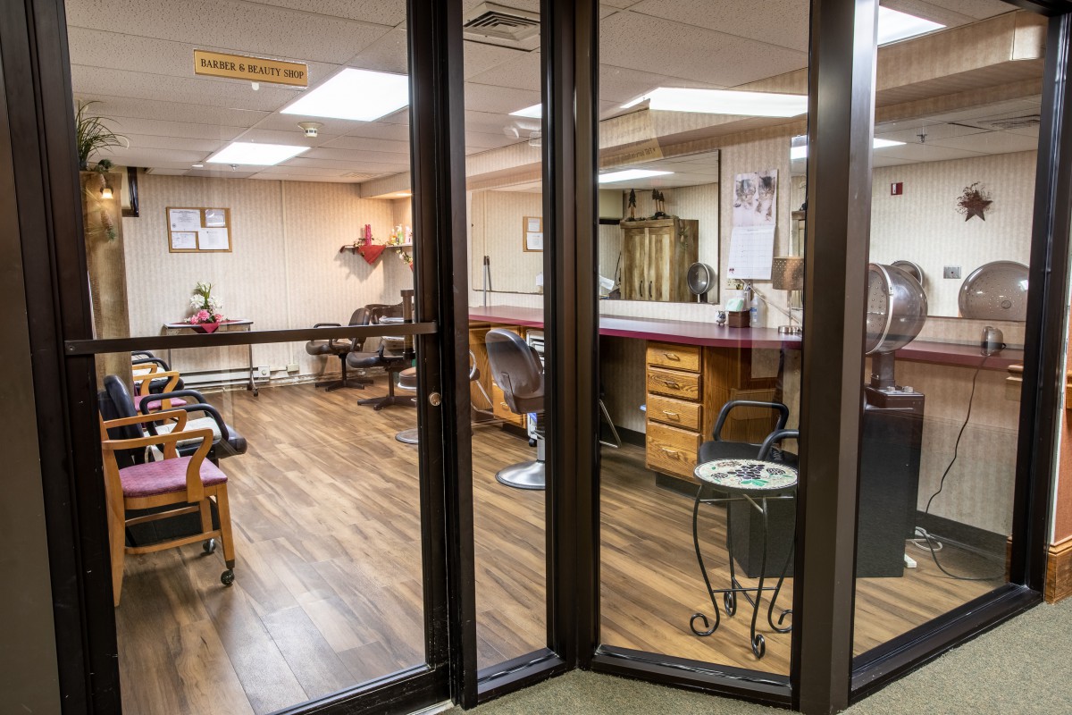 Interior view of a hair salon with multiple workstations and chairs.