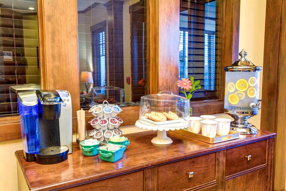 A cozy self-service coffee station with snacks and beverages.