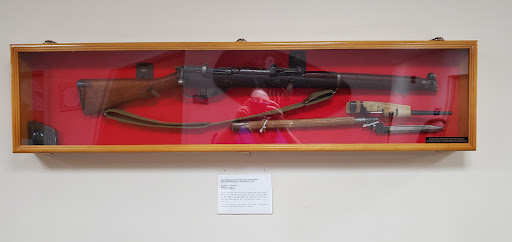 A vintage rifle displayed in a protective case, showcasing its historical significance.