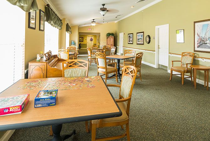 A bright and spacious dining area with tables and chairs arranged neatly.