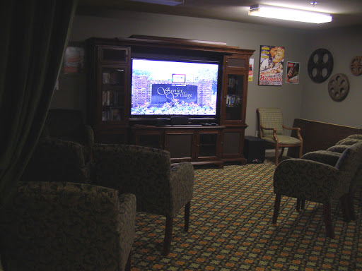 A cozy living room setting featuring a television and comfortable seating.