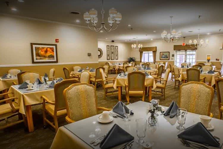 An elegant dining room featuring neatly arranged tables and chairs, ready for guests.
