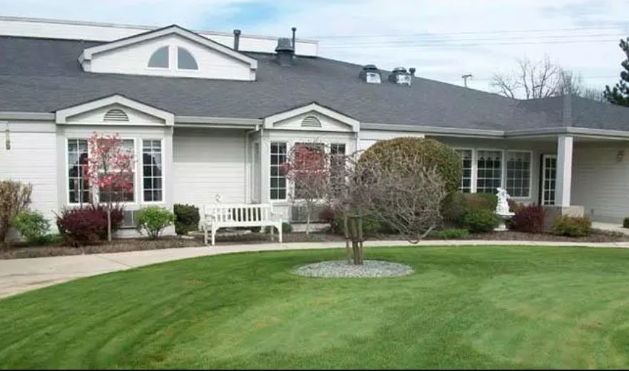A suburban house with a well-maintained lawn and garden.