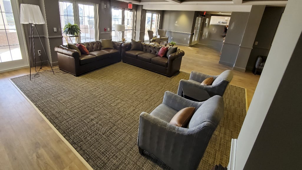 A comfortable lobby area with sofas and chairs arranged for seating.