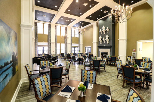 A beautifully designed restaurant featuring an elegant dining area with high ceilings and modern decor.