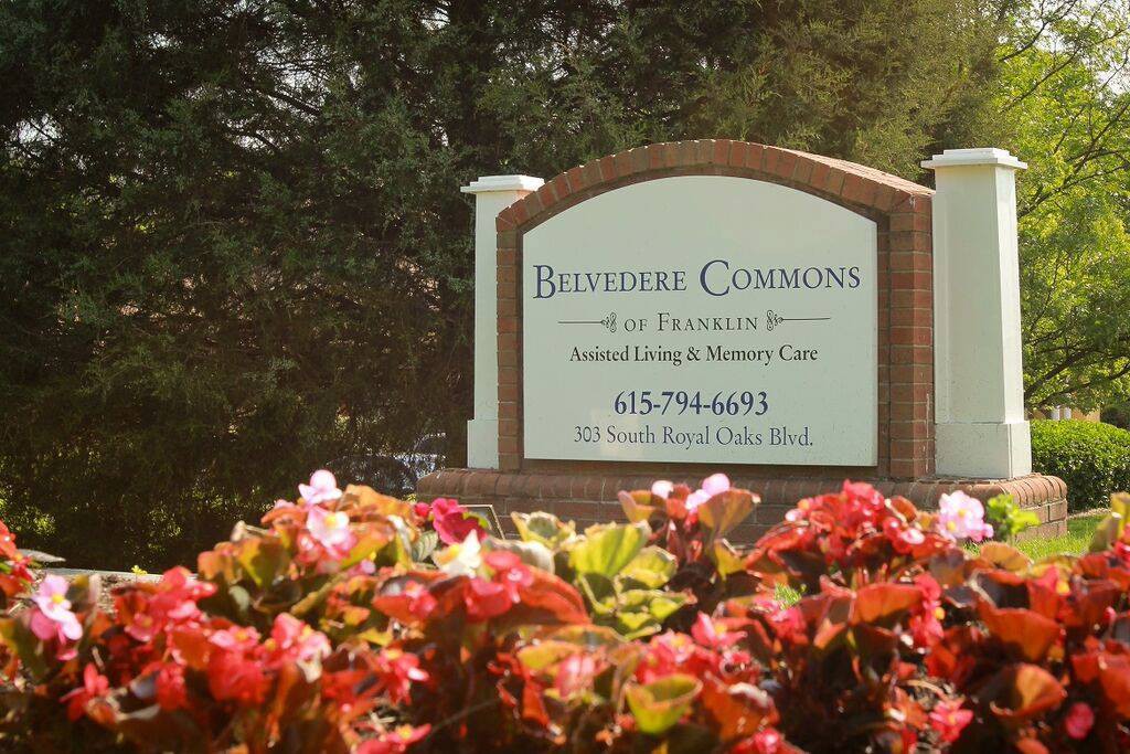 A sign for Bristoe Commons surrounded by blooming flowers.