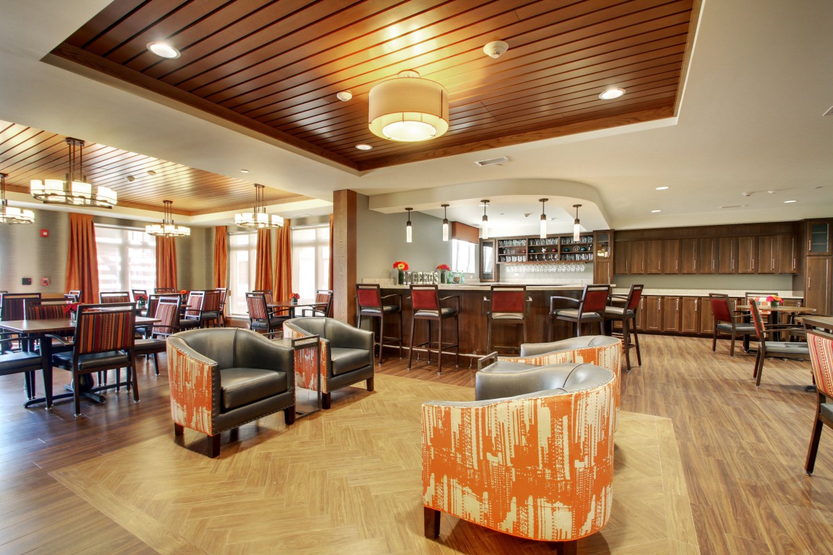 A modern and stylish living and kitchen area with contemporary furniture and lighting.