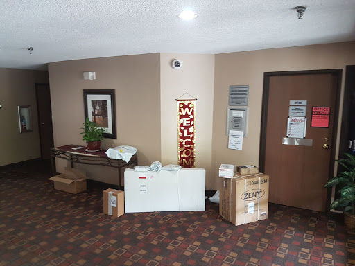 A view of a lobby area featuring furniture and unpacked boxes.