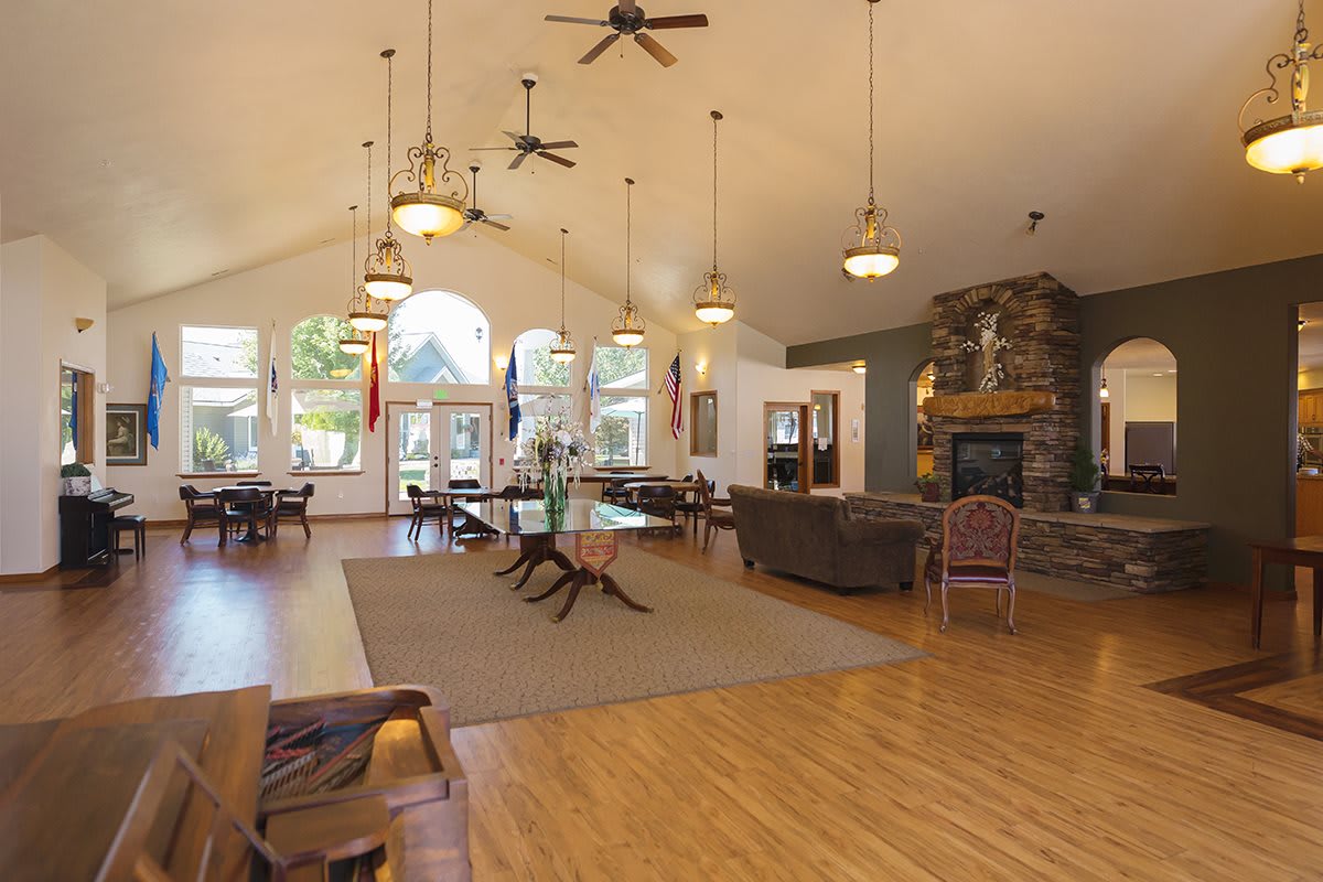 Spacious living area with high ceilings, large windows, and a cozy fireplace.