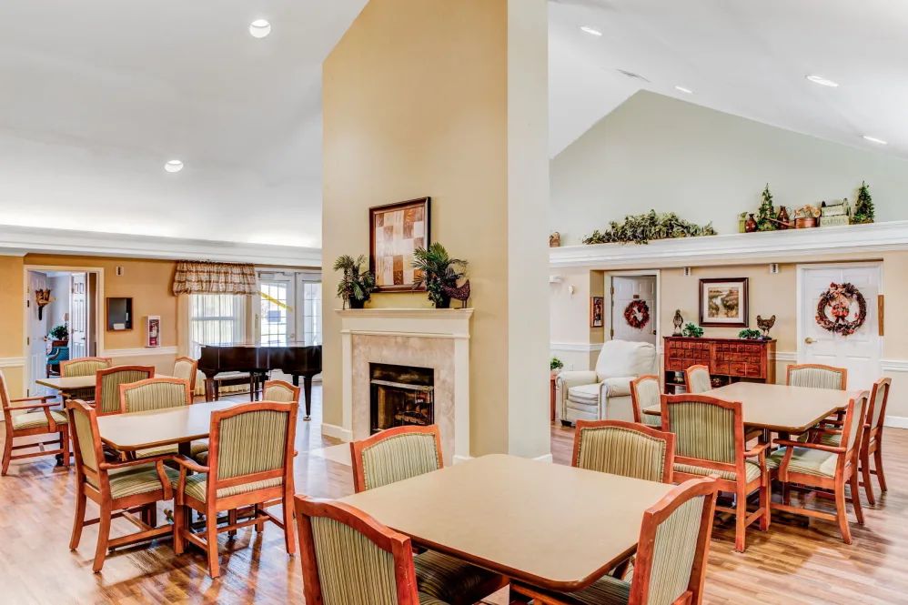 A cozy and elegantly furnished communal living and dining area with a fireplace.